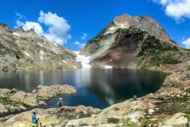 Foggy Lake in Gothic Basin ringed by bare granite, with Del Campo Peak behind