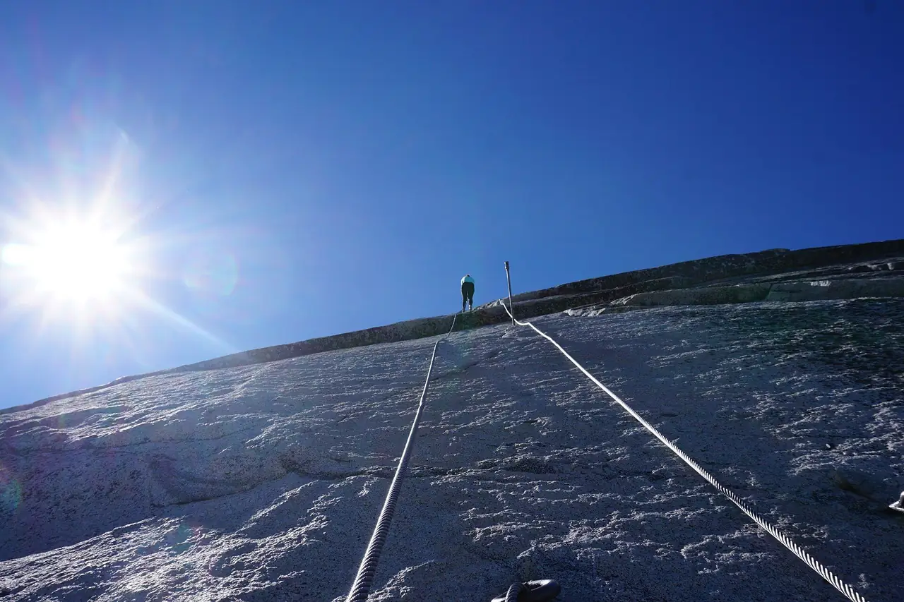 Looking down the Half Dome cables with the sun low over the granite