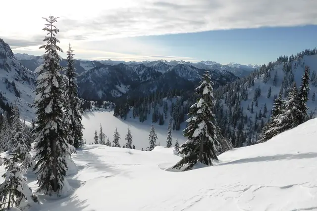 Lake Valhalla buried in December snow, seen from the slope of Mount McCausland