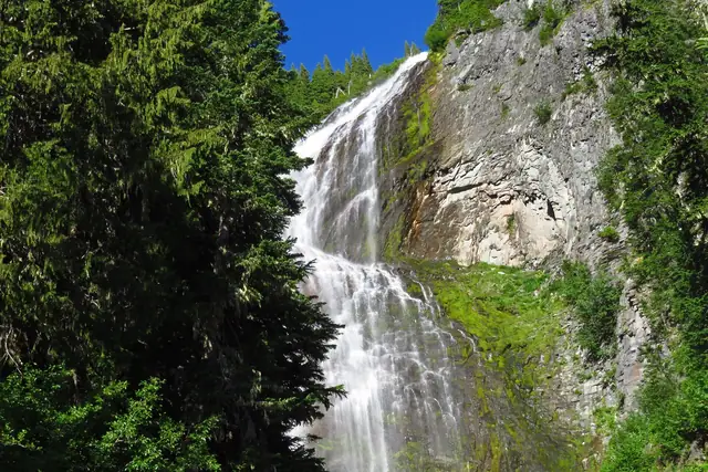 Spray Falls fanning down a mossy cliff on the way to Spray Park
