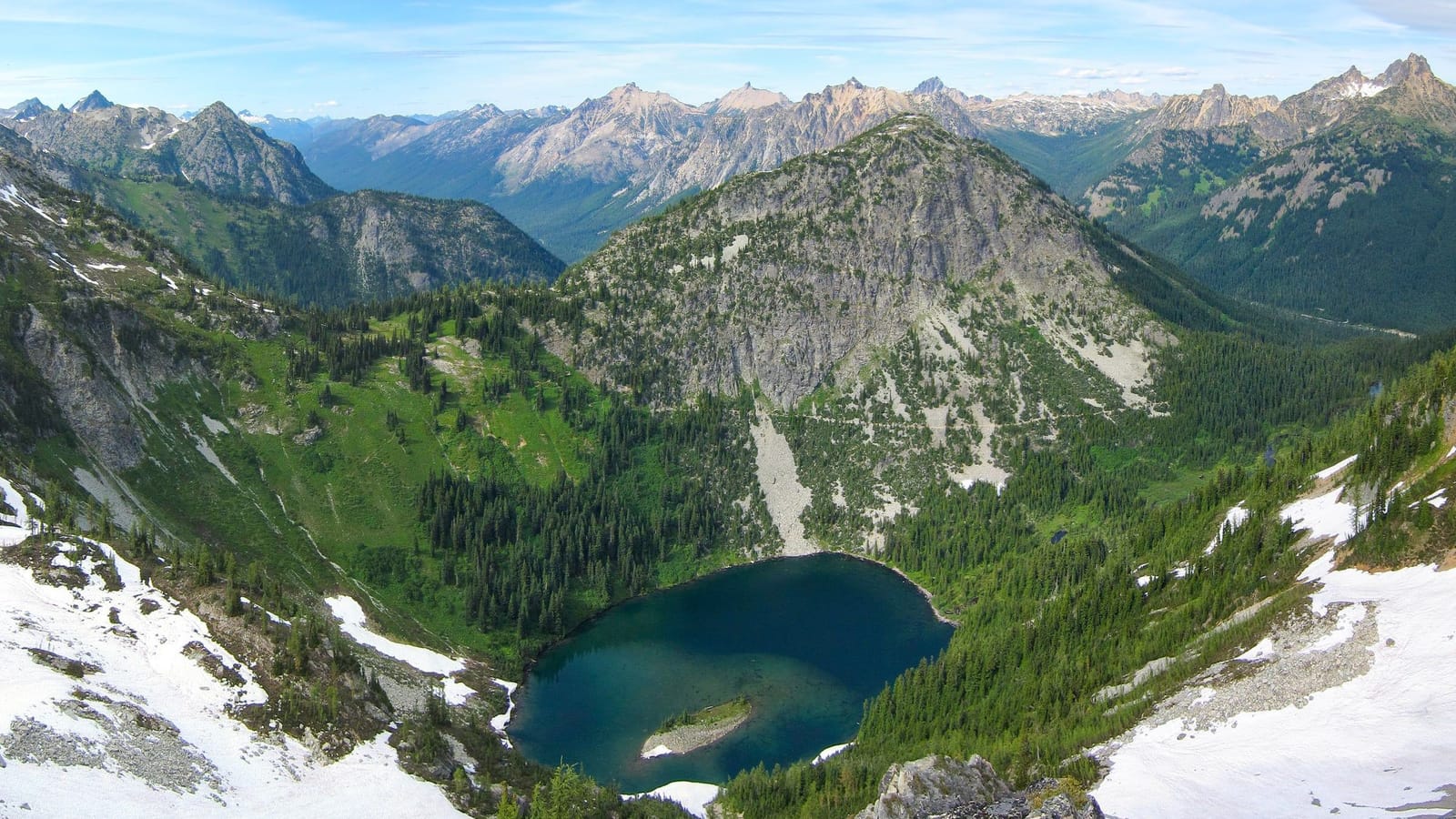 Looking down on Lake Ann and its small island from Maple Pass, with North Cascades peaks behind